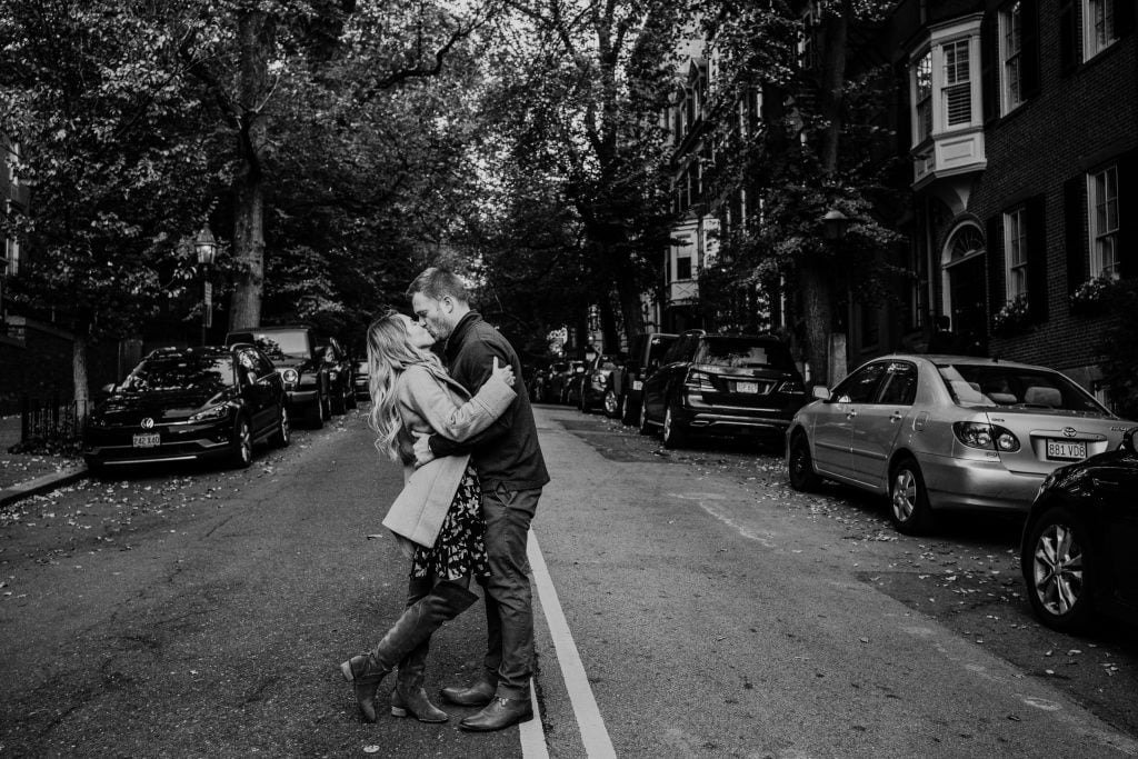 black and white photo of couple kissing on a beacon hill street during their boston engagement session