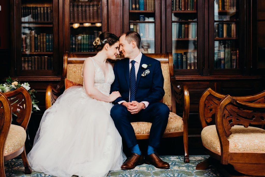 wedding couple in the lyman estate library during their historic new england summer wedding