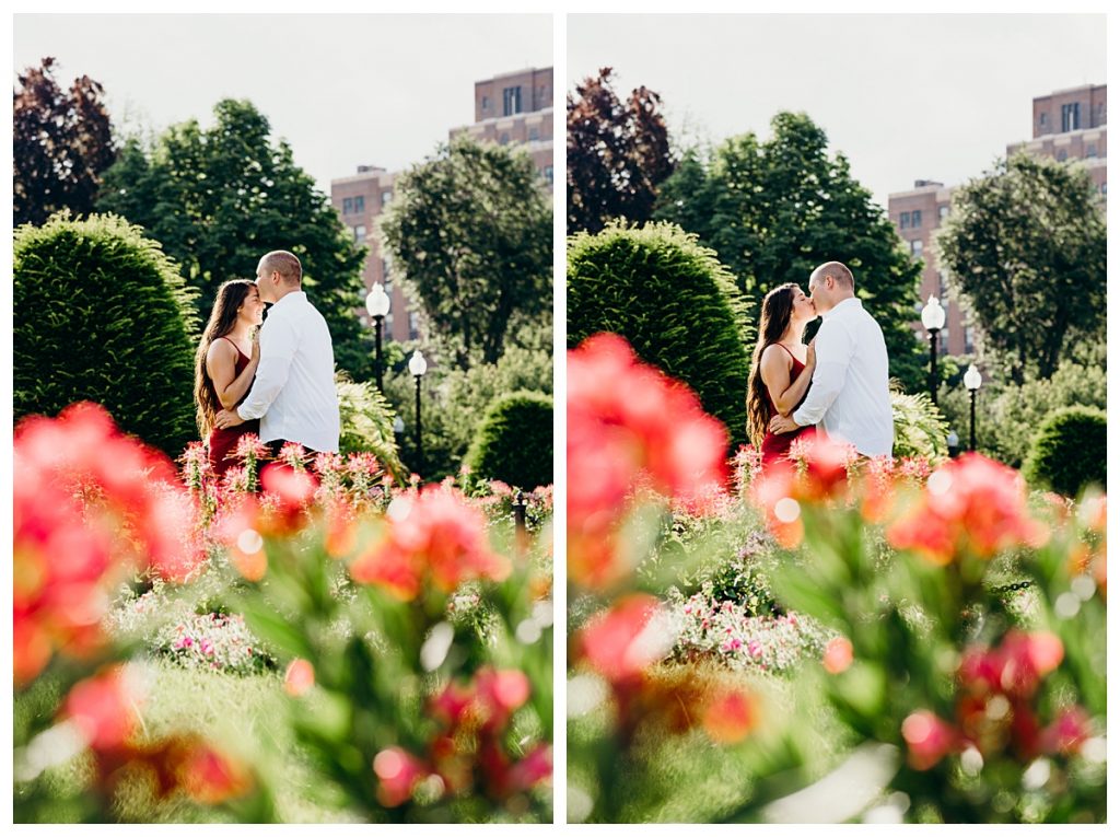 engaged couple kissing in the Boston Public Garden with tulips in the foreground during their spring engagement photos