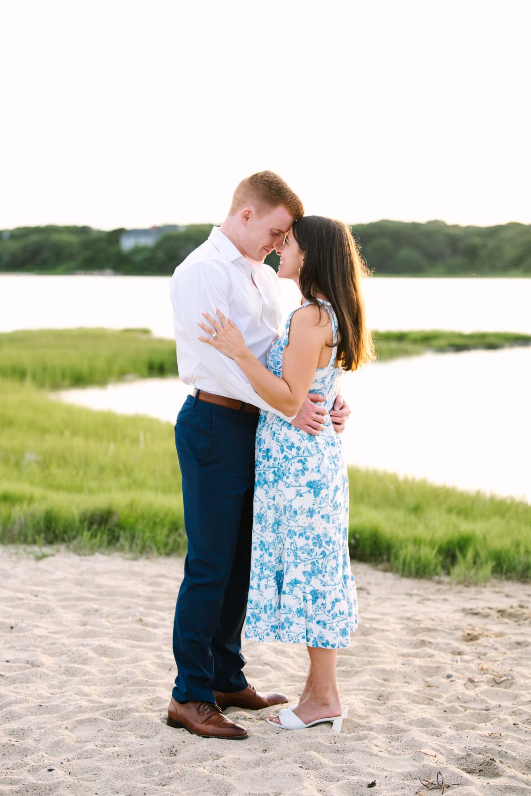 just engaged couple with their heads resting against each other during their falmouth cape cod engagement session