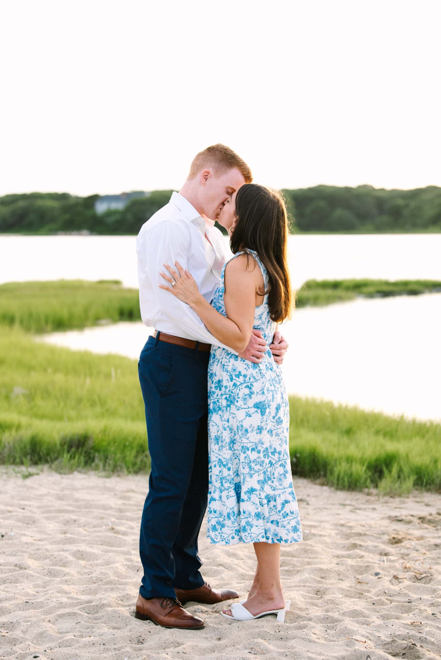 just engaged couple kissing each other during their falmouth cape cod sunset engagement session