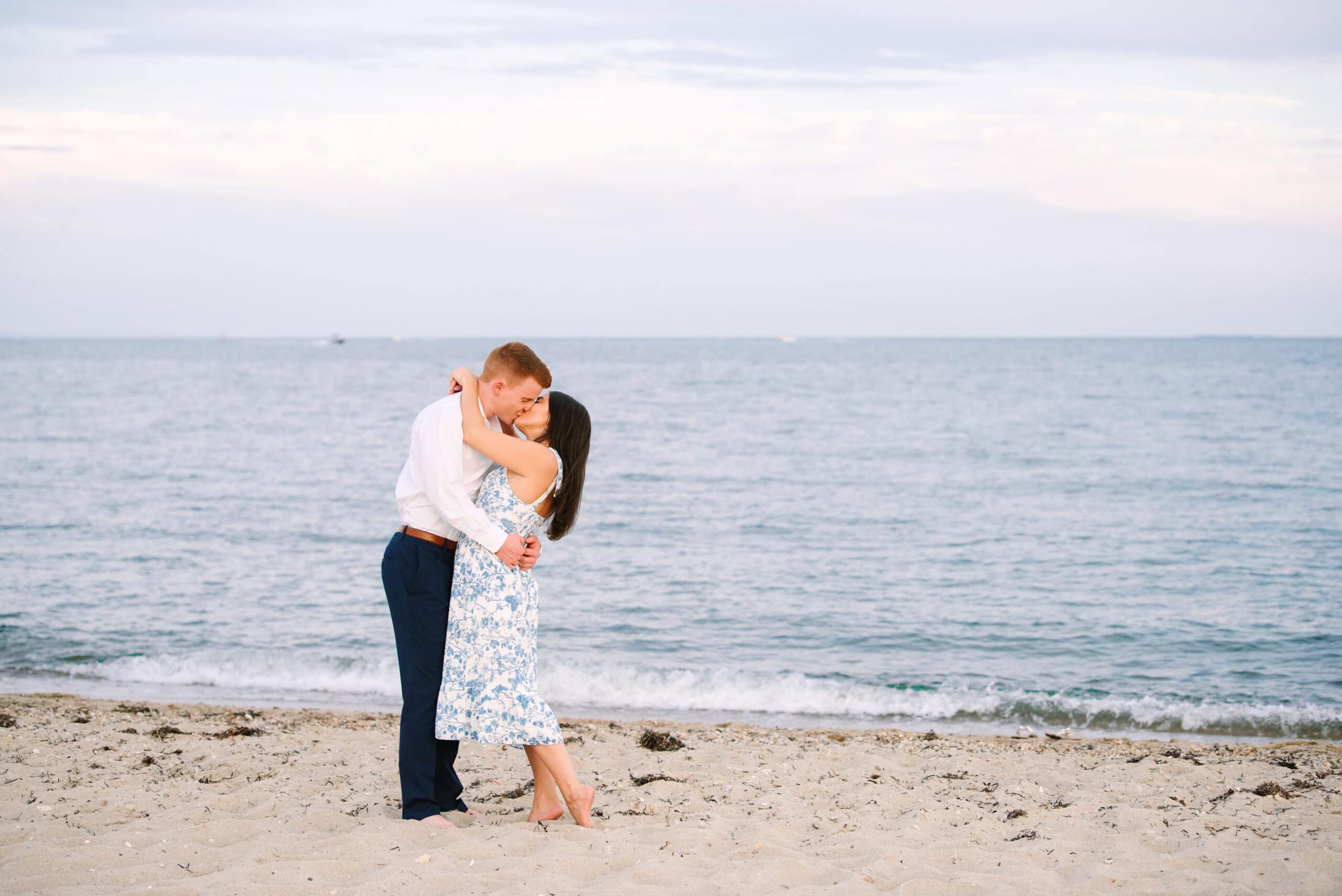 just engaged couple kissing on menahaunt beach during their falmouth cape cod surprise proposal session