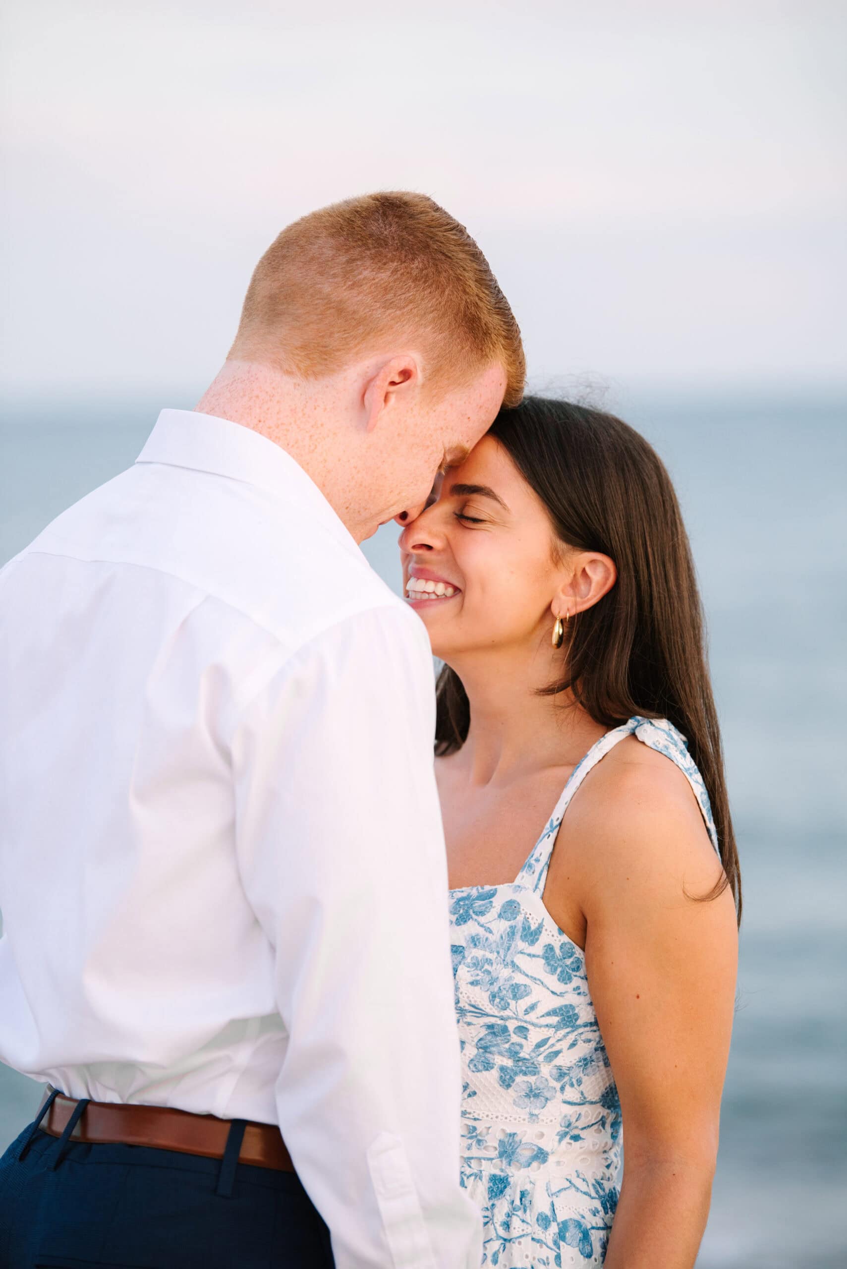 close up of woman smiling at fiance during a cape cod surprise proposal session on menahaunt beach 