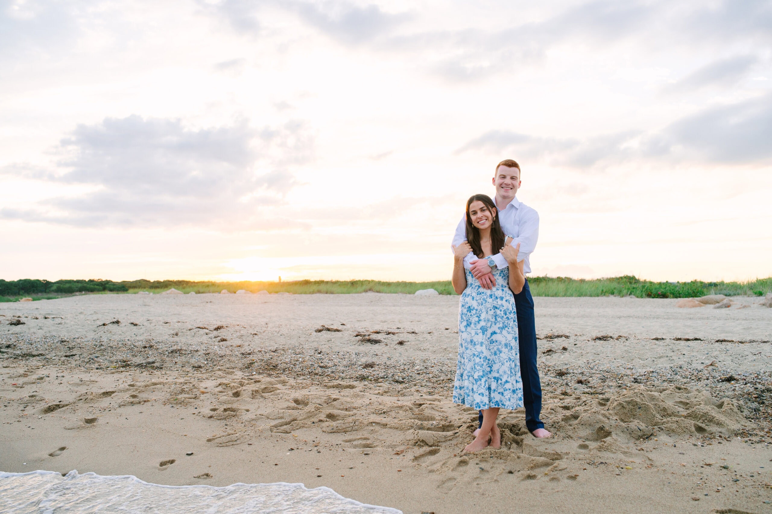 just engaged couple arm and arm on menahaunt beach during their cape cod surprise proposal session