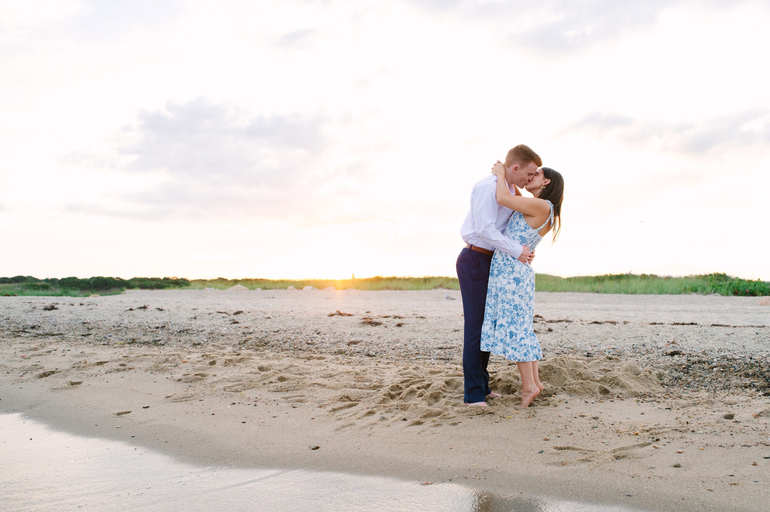 just engaged couple kissing on menahaunt beach during their cape cod surprise proposal session