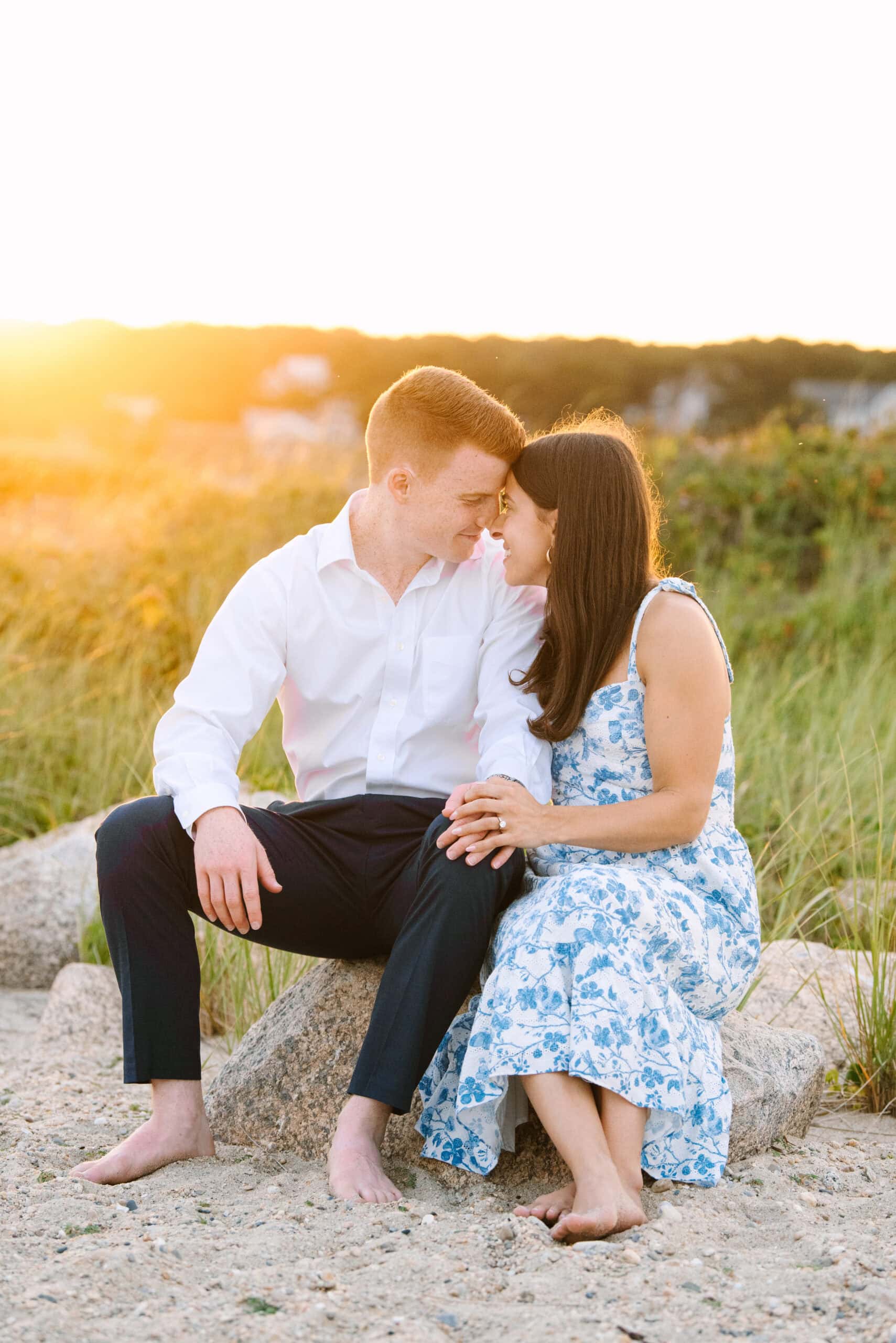 just engaged couple smiling at each other on menahaunt beach during their falmouth cape cod surprise proposal session