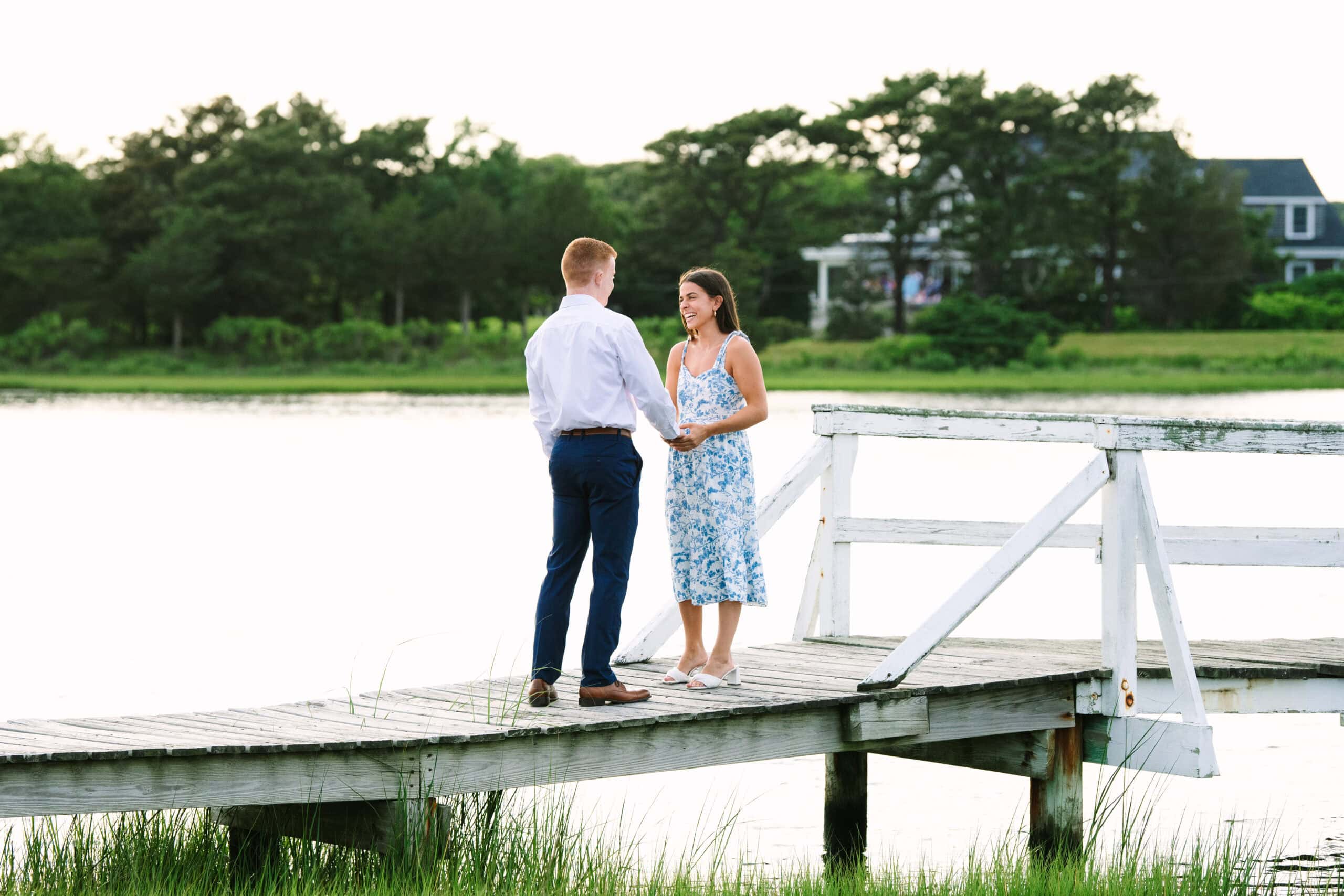 guy holding his girlfriend's hand on a bridge before proposing in falmouth cape cod