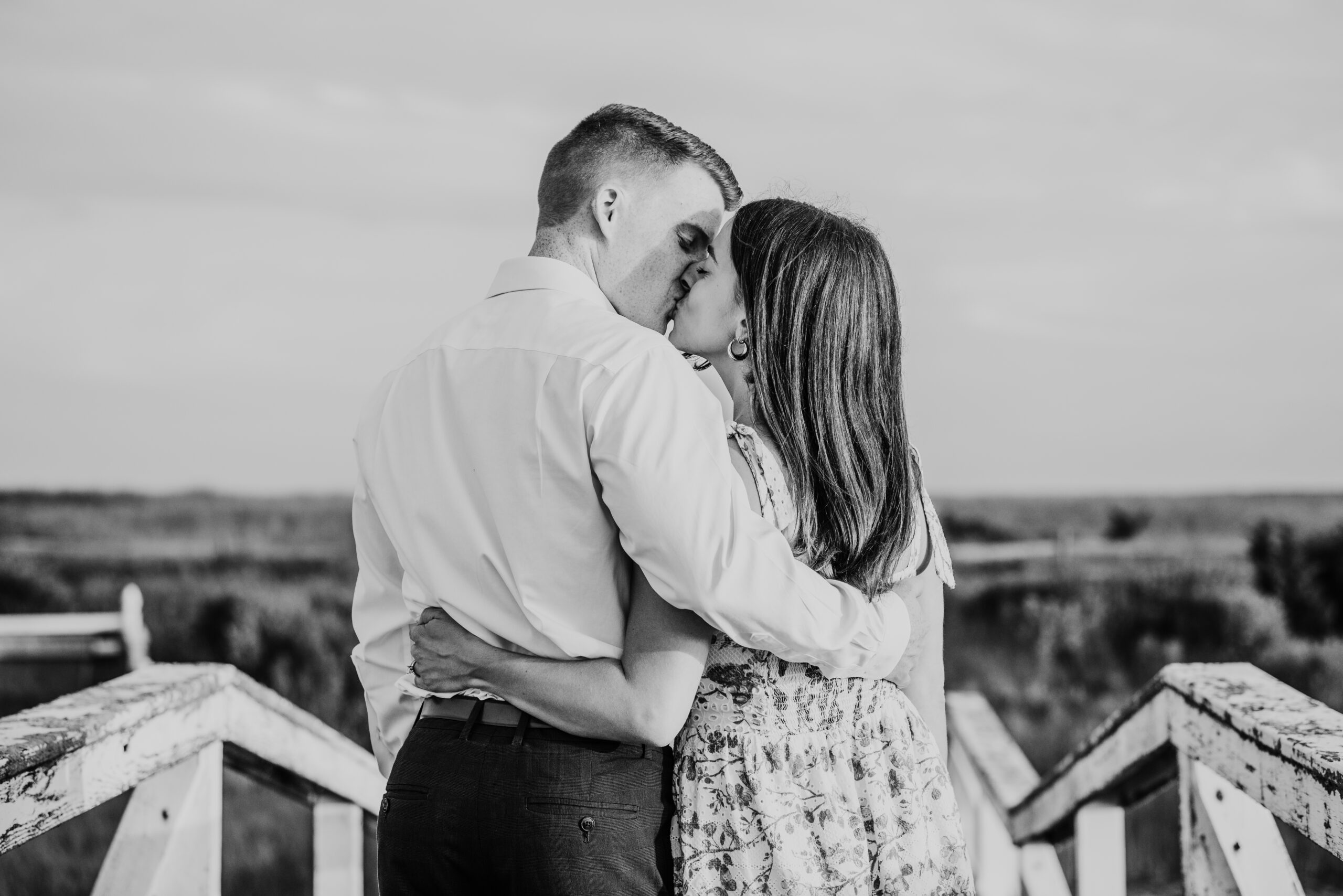 black and white photo of couple kissing during their cape cod surprise proposal session in massachusetts