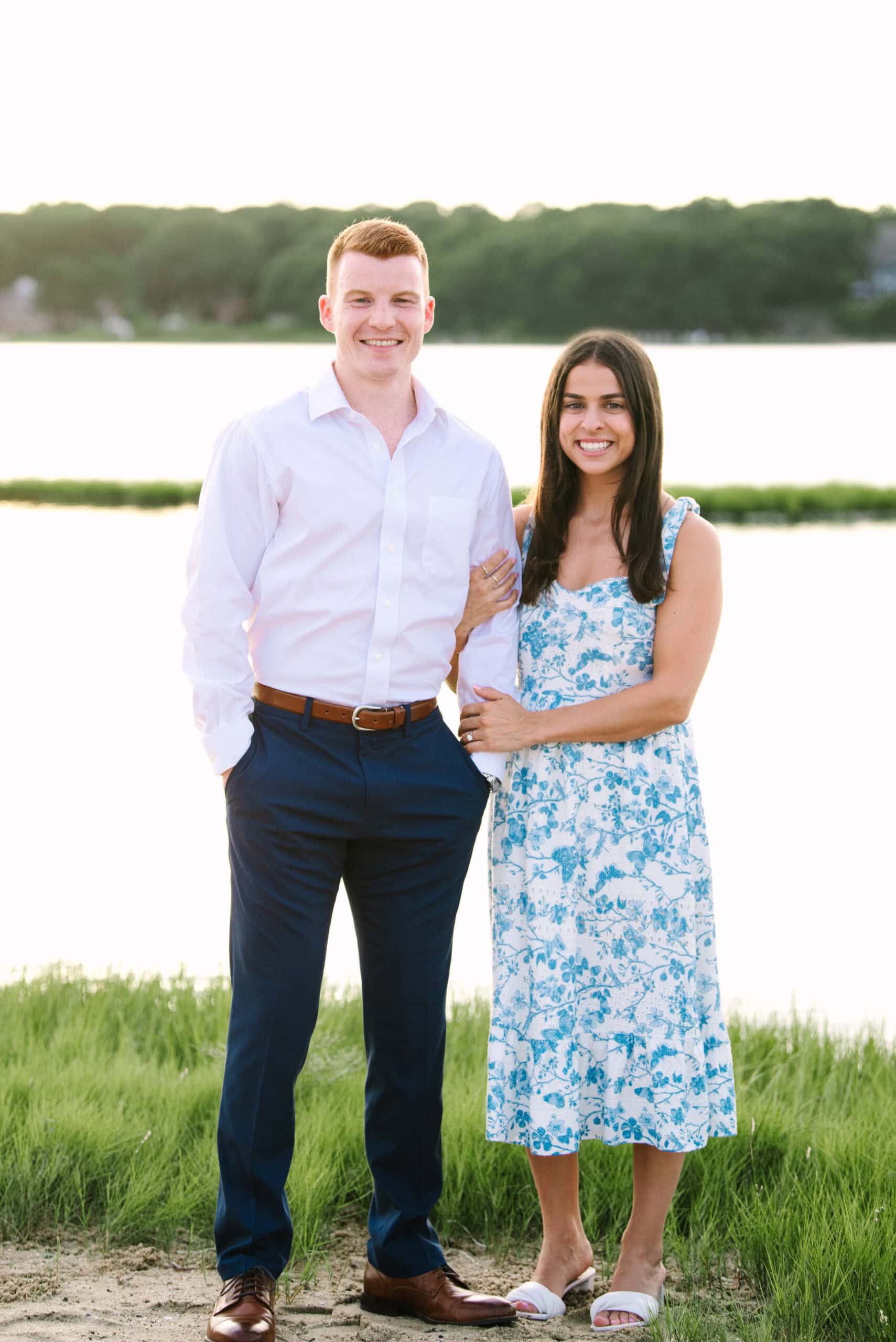 just engaged couple smiling at the camera during their sunset falmouth cape cod engagement session