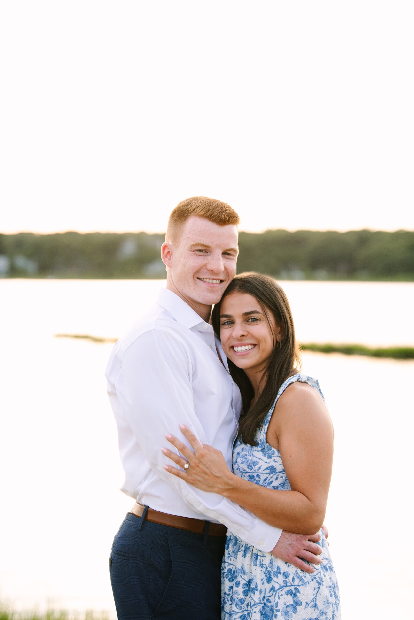 just engaged couple smiling at the camera during their sunset falmouth cape cod engagement session