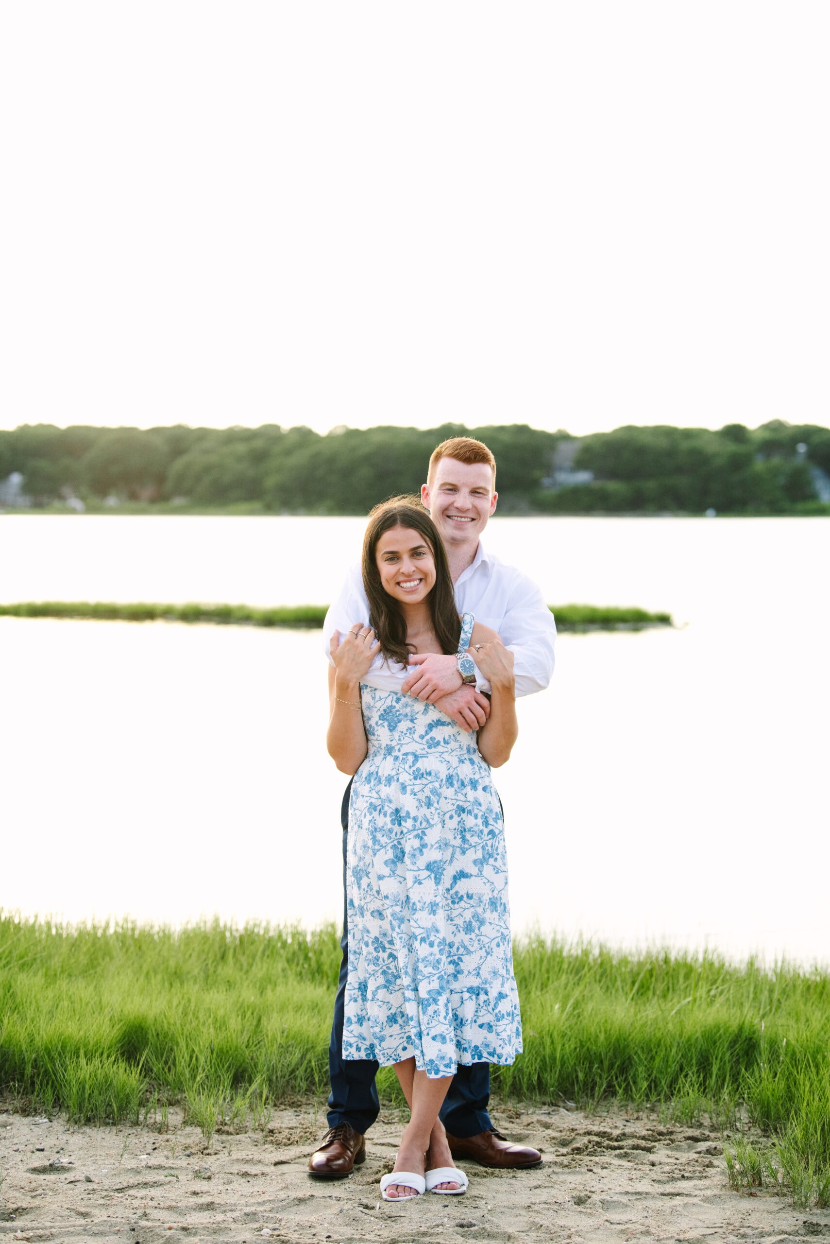 just engaged couple smiling at the camera during their sunset falmouth cape cod engagement session