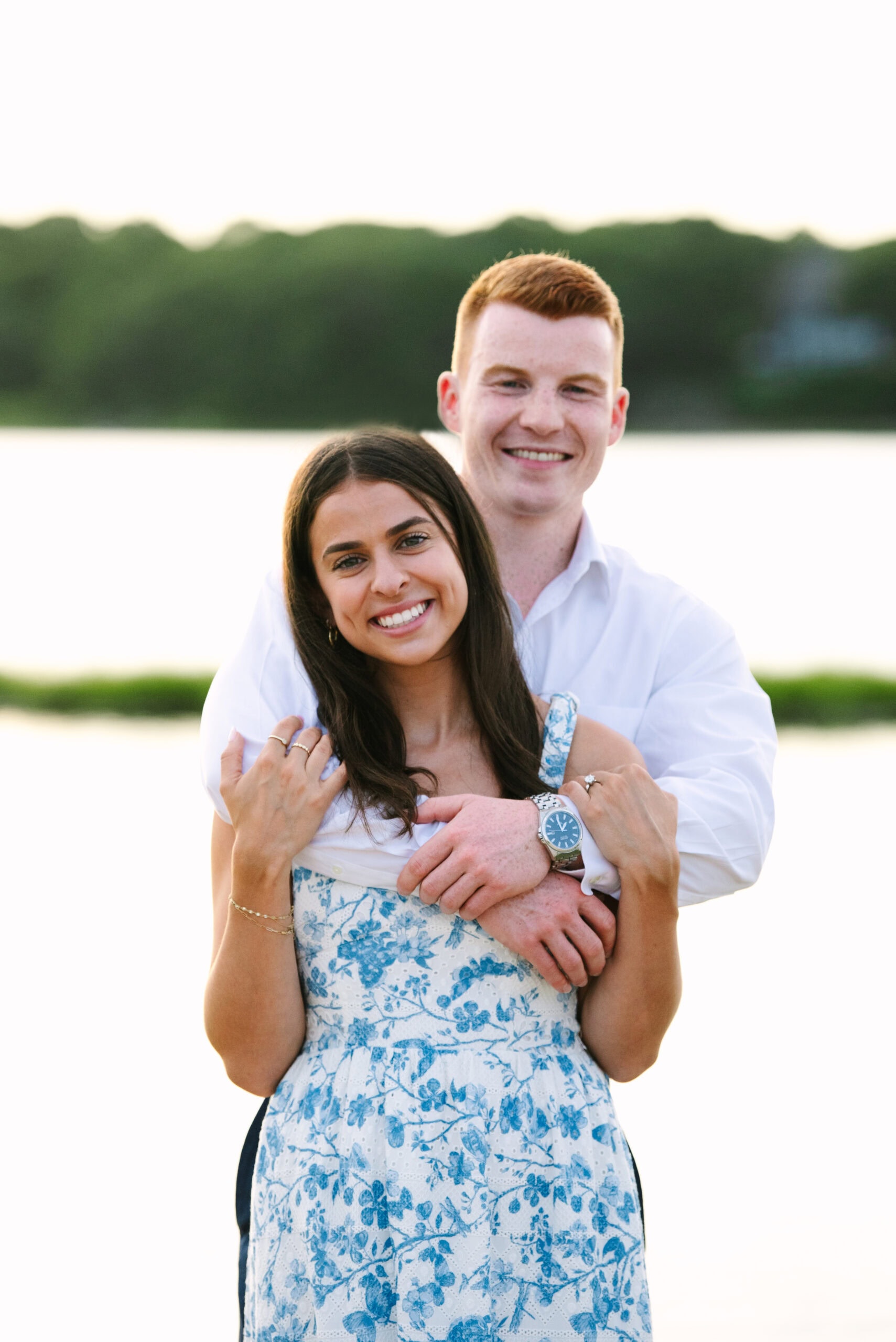 just engaged couple smiling at the camera during their sunset falmouth cape cod engagement session