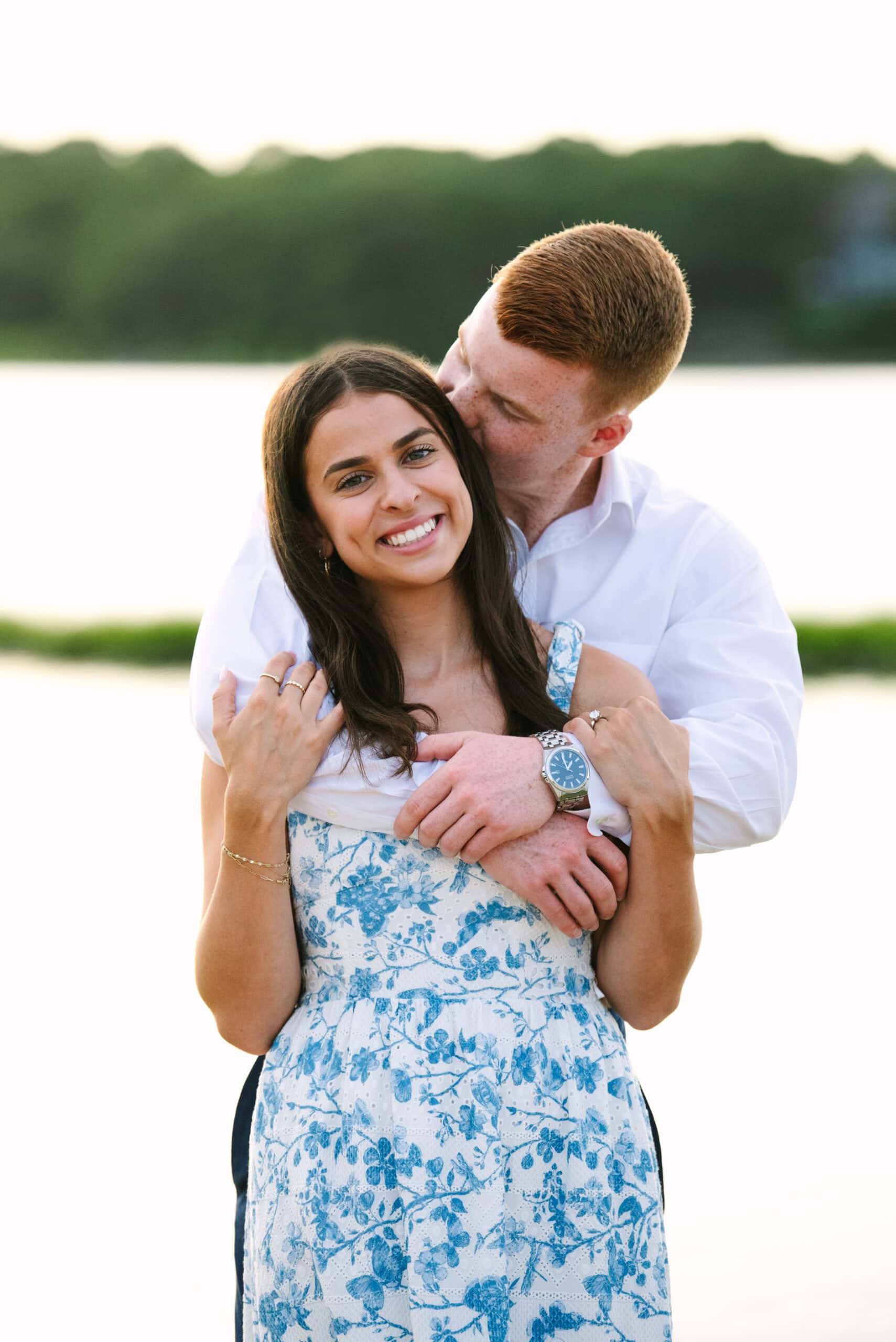 guy kissing fiance on the cheek during their sunset falmouth cape cod engagement session