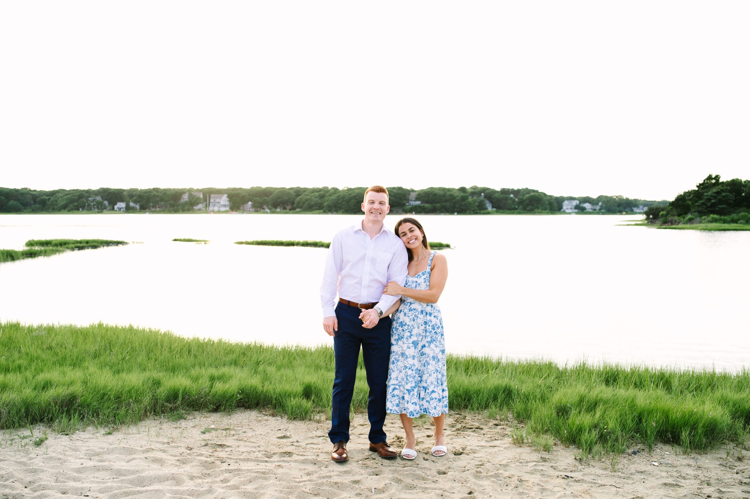 just engaged couple arm in arm smiling during their cape cod surprise proposal session captured by Meghan Lynch