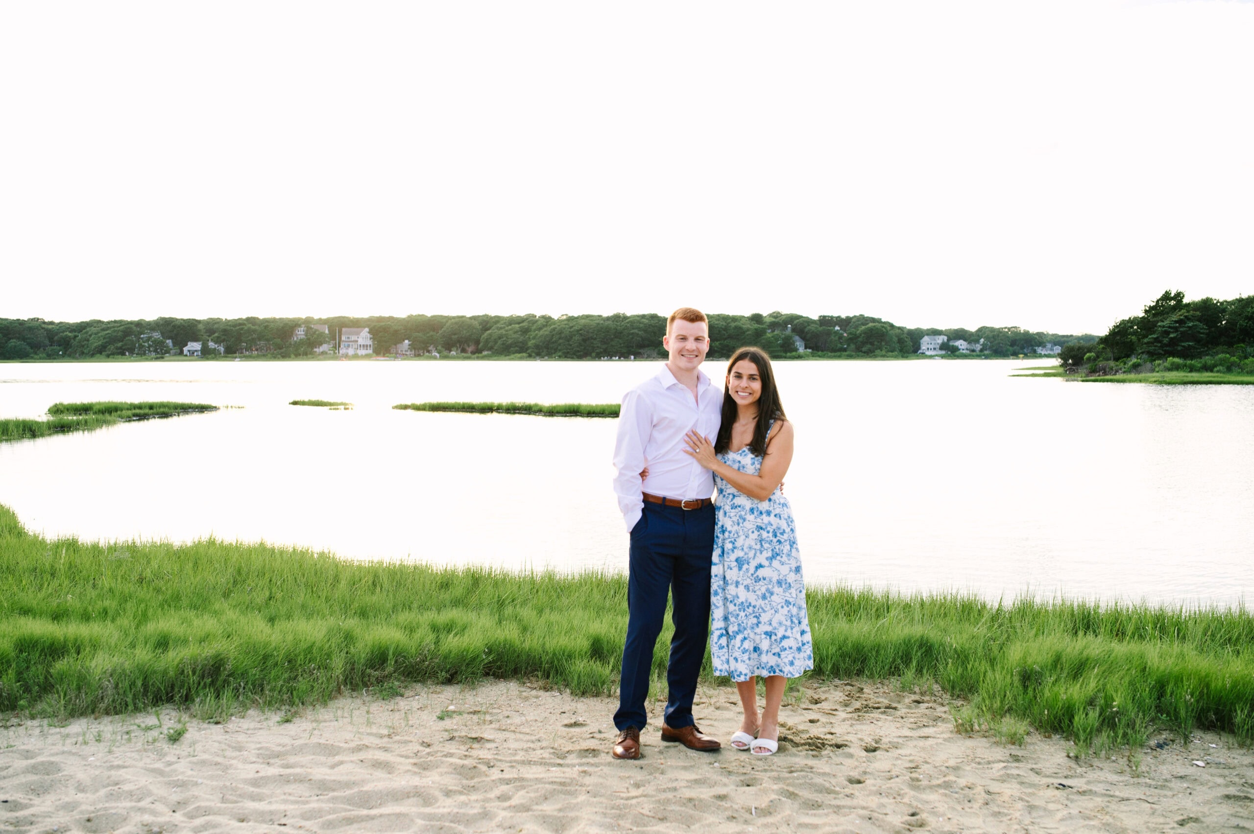 just engaged couple arm in arm smiling during their cape cod surprise proposal session captured by Meghan Lynch