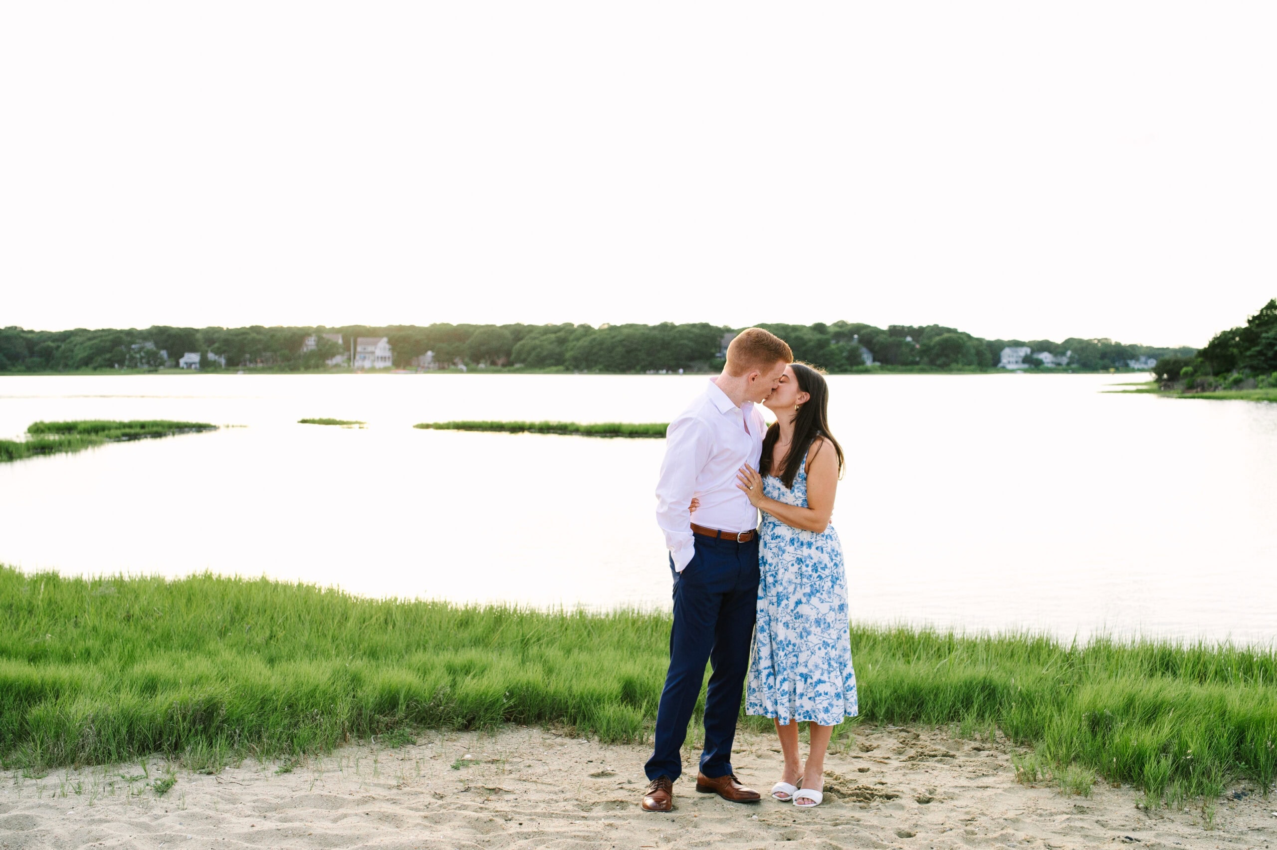 just engaged couple kissing during their cape cod surprise proposal session captured by Meghan Lynch