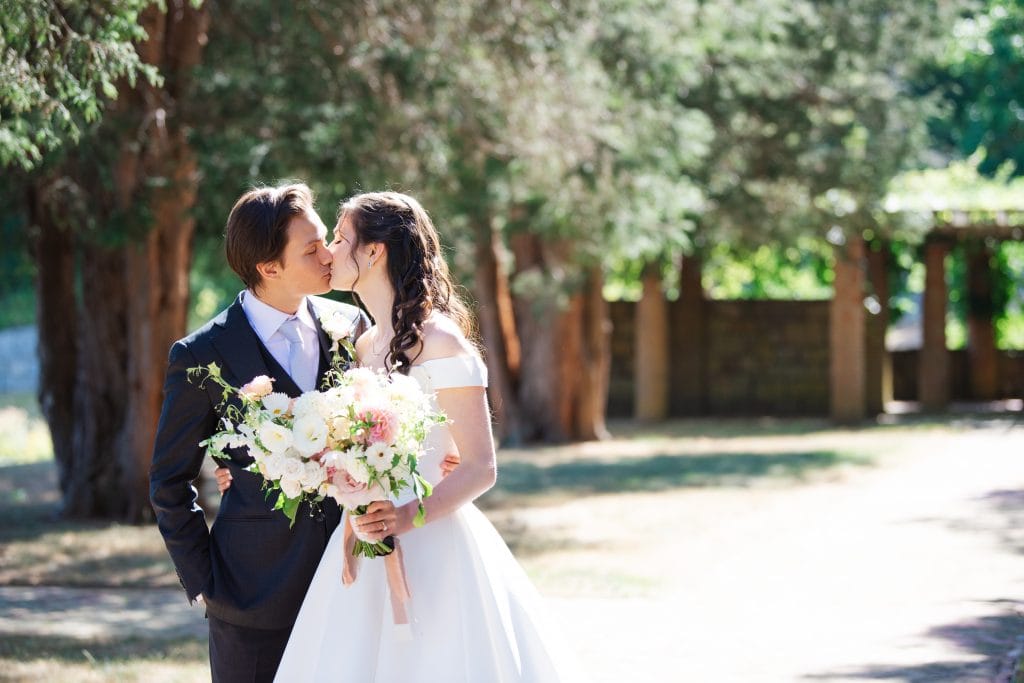 close up of bride and groom kissing in the geometric garden during their north shore massachusetts turner hill wedding