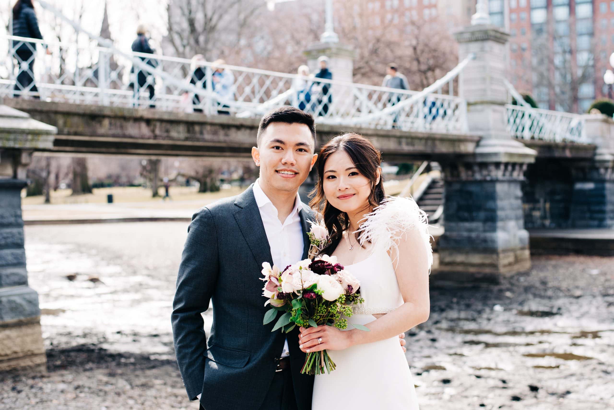 bride and groom portrait in front of the Boston public garden pedestrian bridge captured by Boston elopement photographer Meghan Lynch