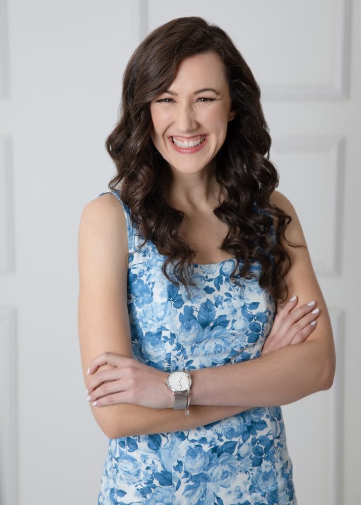 massachusetts wedding photographer meghan lynch smiling with her arms crossed for her headshot