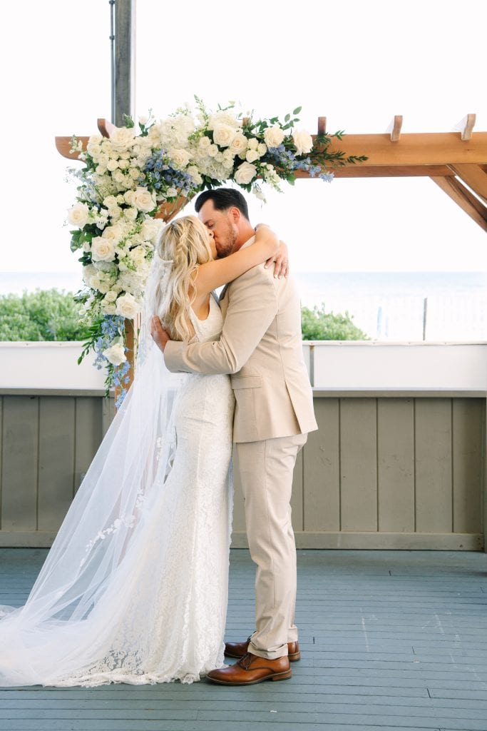 bride and groom first kiss at the club at New Seabury Popponesset Inn on Cape Cod