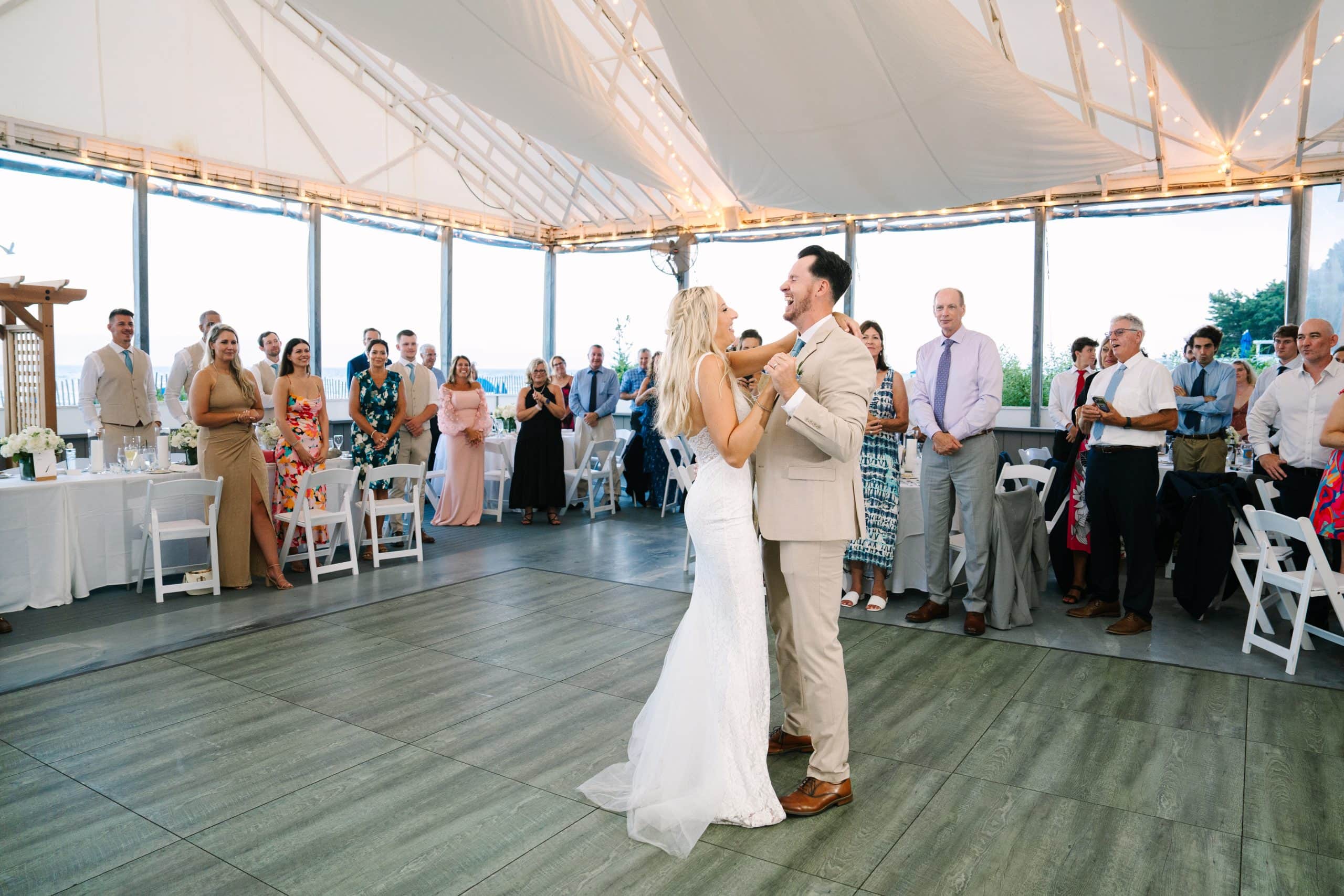 bride and groom laughing during their first dance at their Popponesset Inn wedding in Mashpee, MA