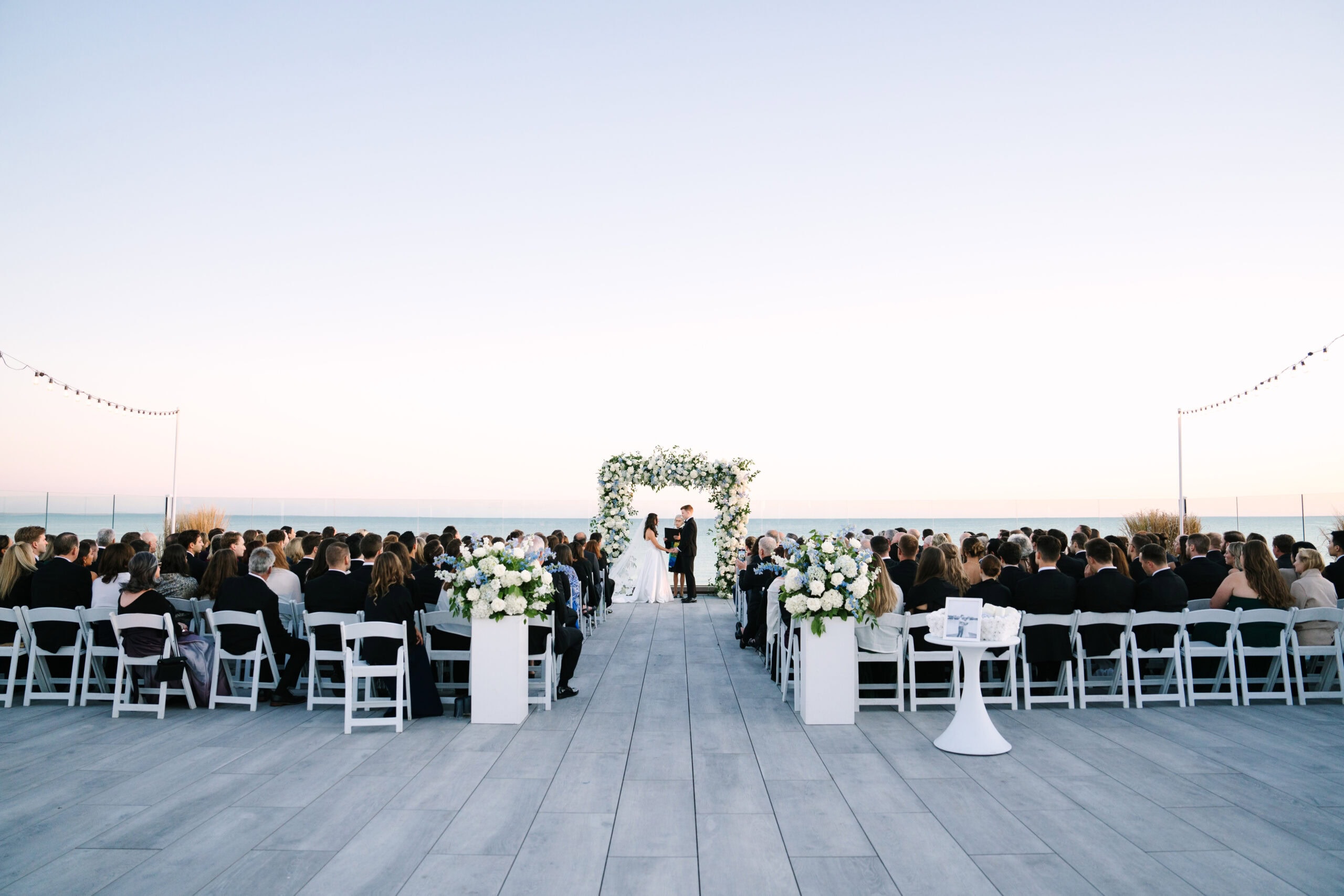 bride and groom during their wychmere beach club wedding ceremony at sunset