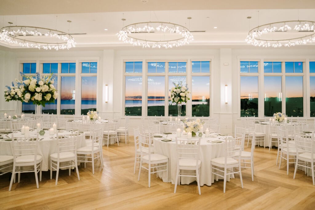 wychmere beach club dune reception tables with the sun setting in the windows during a Harwich Port wedding 