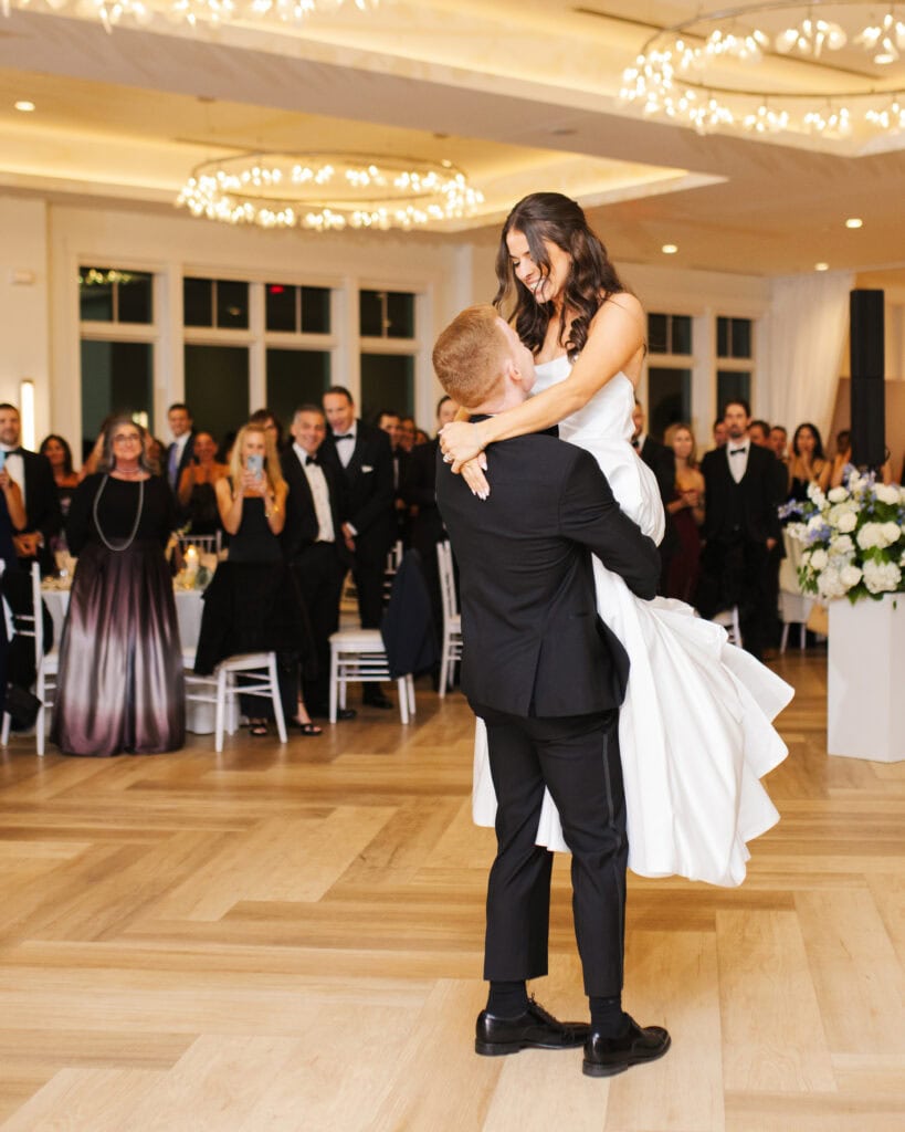 groom lifting bride during the first dance at their wychmere beach club wedding on cape cod