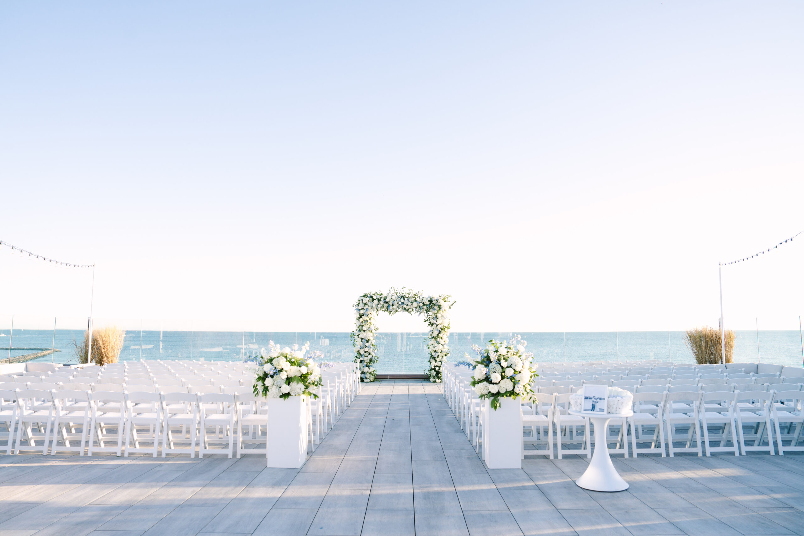 wychmere dune rooftop ceremony with no guests and large floral arch during a cape cod wedding