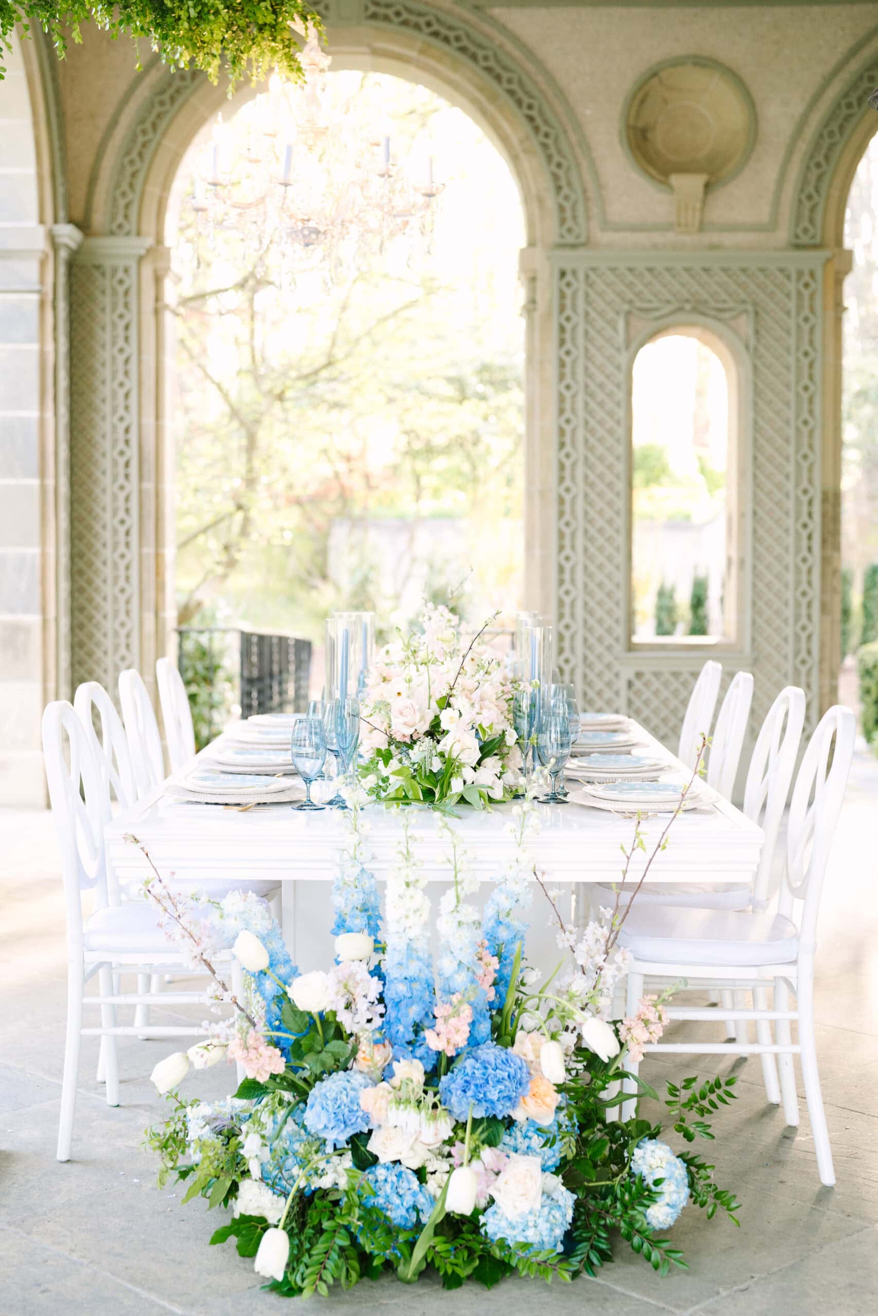 vertical shot of reception table with flowers in front at a Glen Manor House wedding in Rhode Island