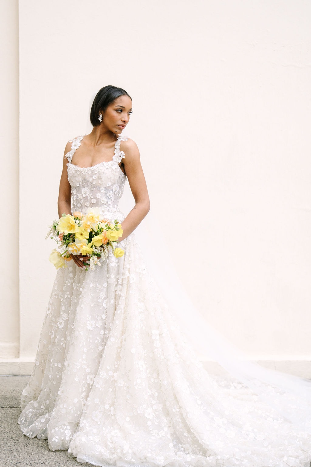 full body portrait of a bride looking off her shoulder at the wadsworth mansion at long hill