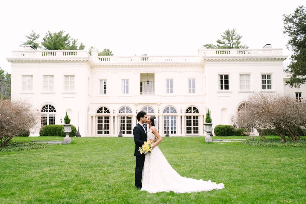 bride and groom kissing in front of the wadsworth mansion during their middletown connecticut wedding