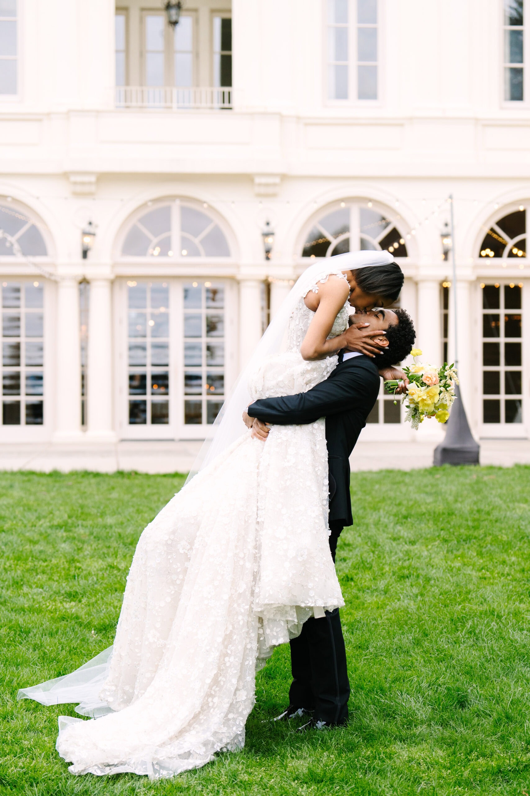 groom lifting up bride for a kiss during their wadsworth mansion wedding in middletown connecticut