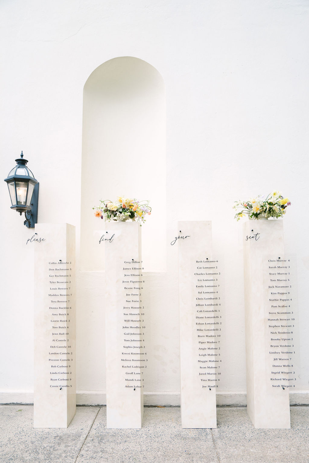 seating chart on four white pillars at a wadsworth mansion wedding reception