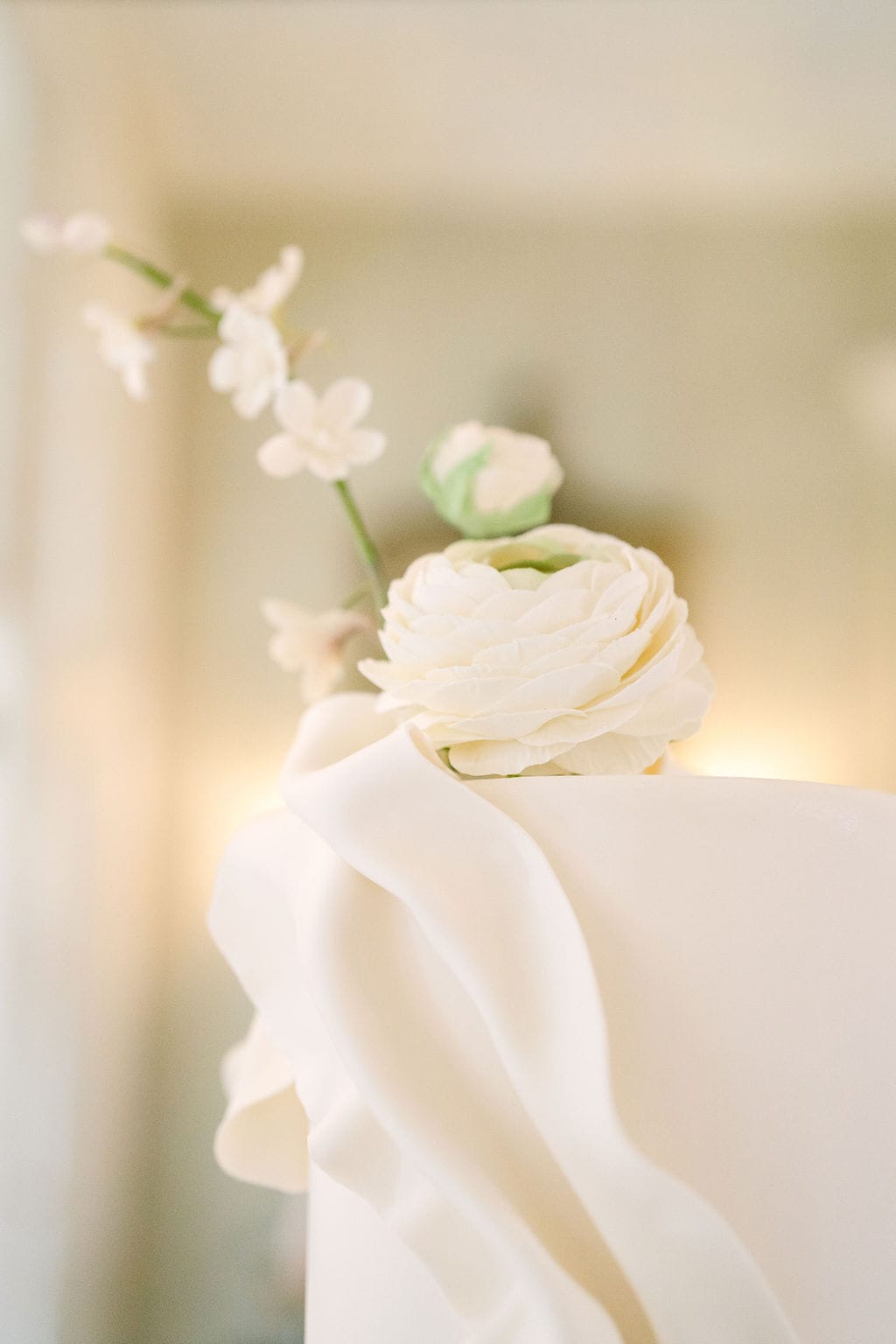 close up of the top of a wedding cake and flower at a wadsworth mansion wedding in connecticut