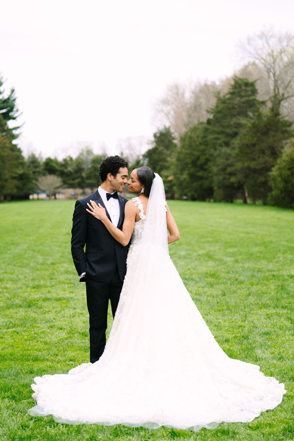 full body portrait of bride and groom with nose's touching at their wadsworth mansion wedding