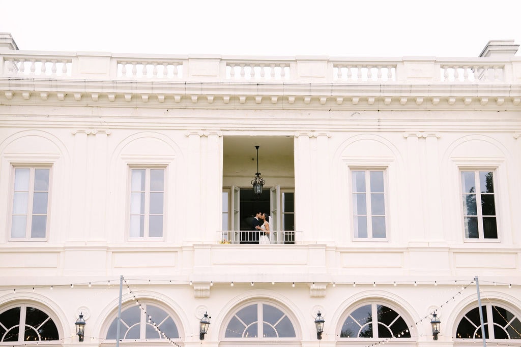 bride and groom kissing on the second floor balcony of the wadsworth mansion during their connecticut wedding