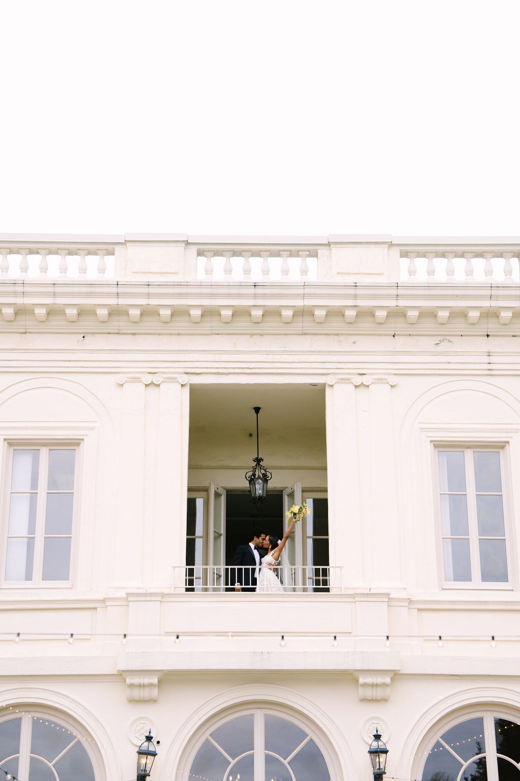 bride and groom kissing on the second floor balcony of the wadsworth mansion during their connecticut wedding