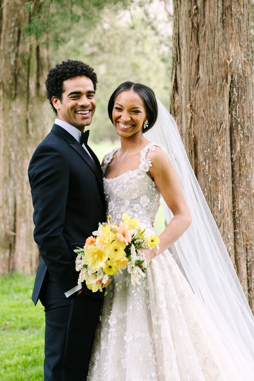 close up portrait of the bride and groom laughing amongst the trees during their wadsworth mansion wedding