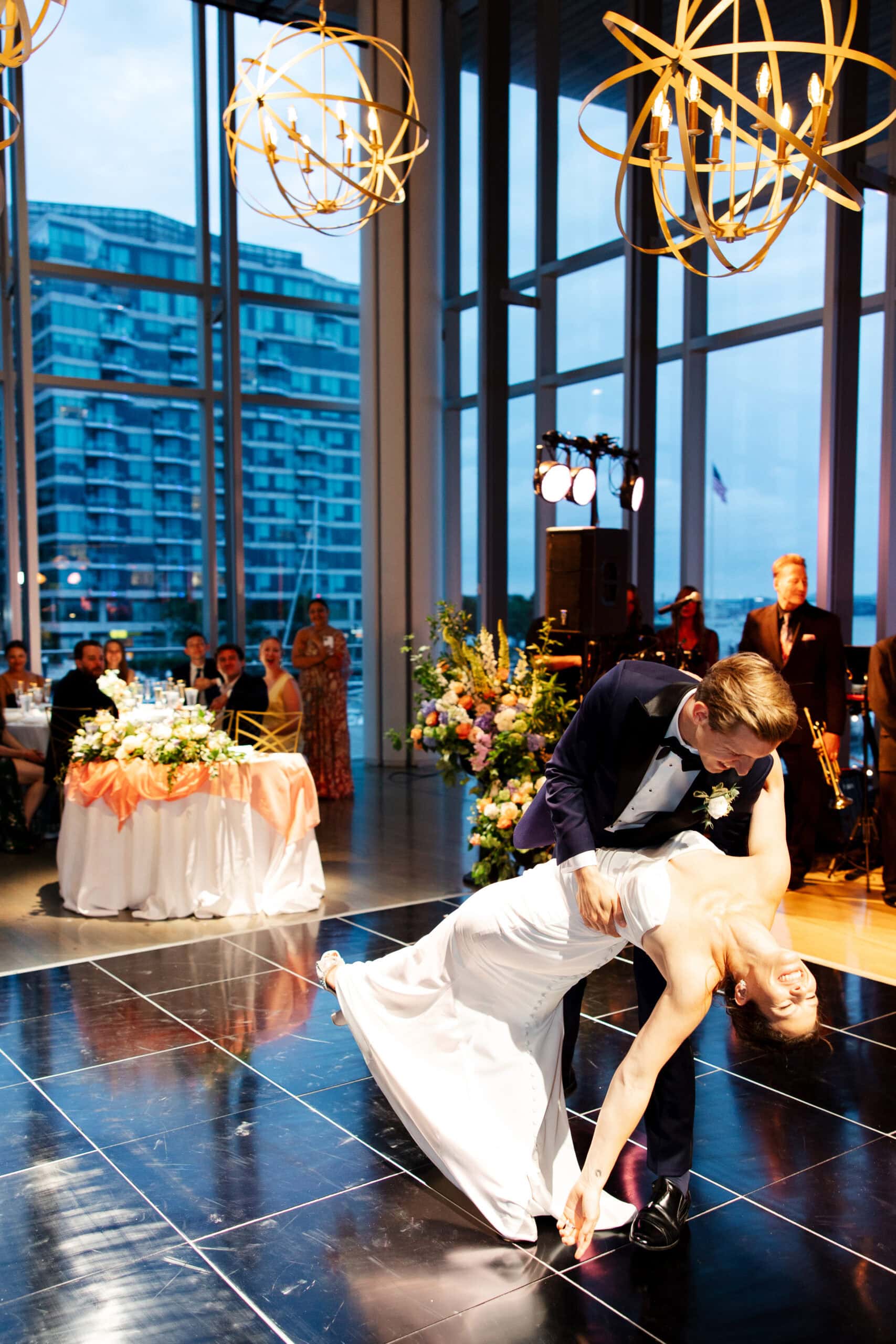 groom dips bride during their first dance at their ica boston wedding 