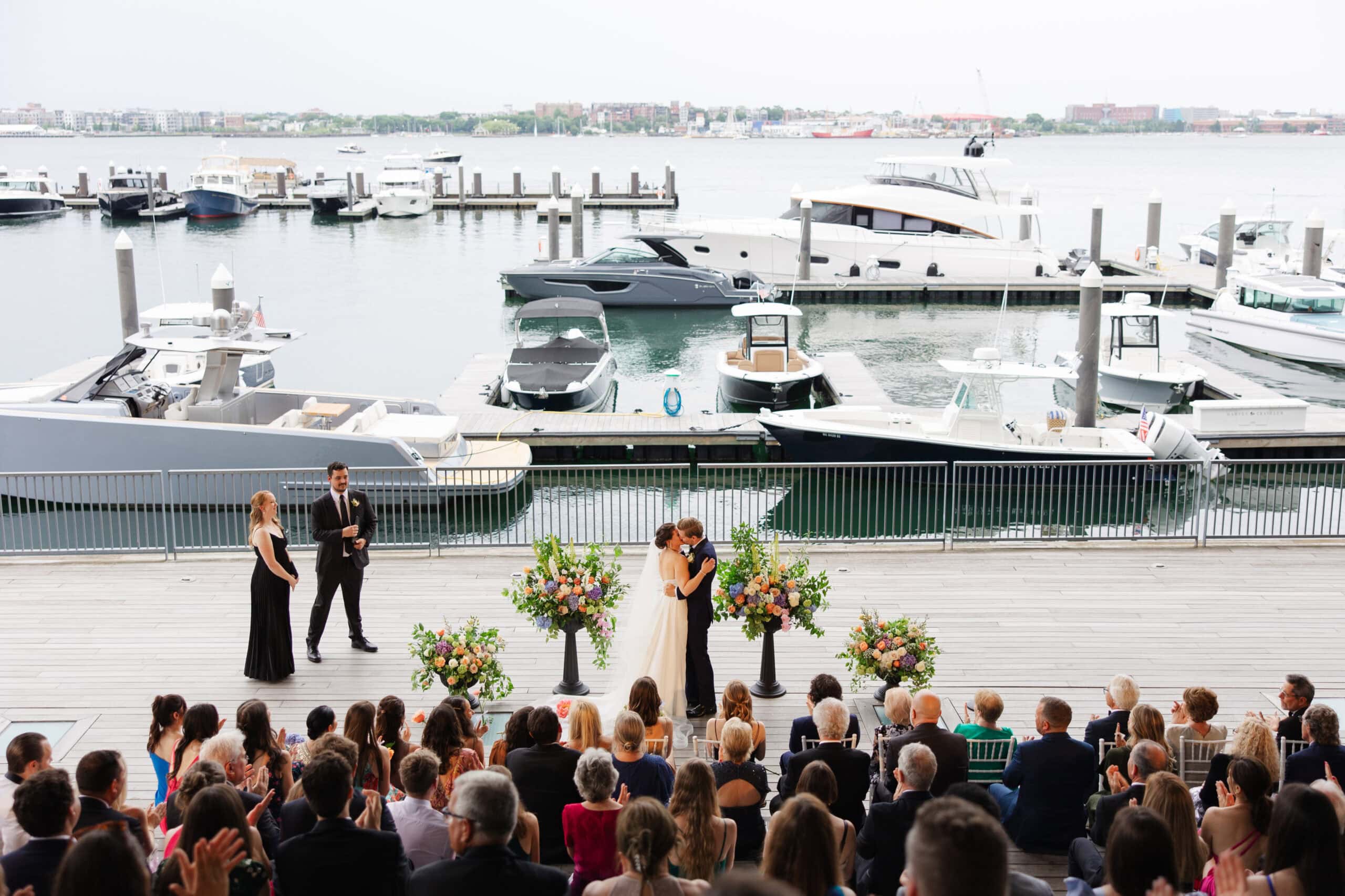 bride and groom first kiss at their institute of contemporary art wedding in boston massachusetts