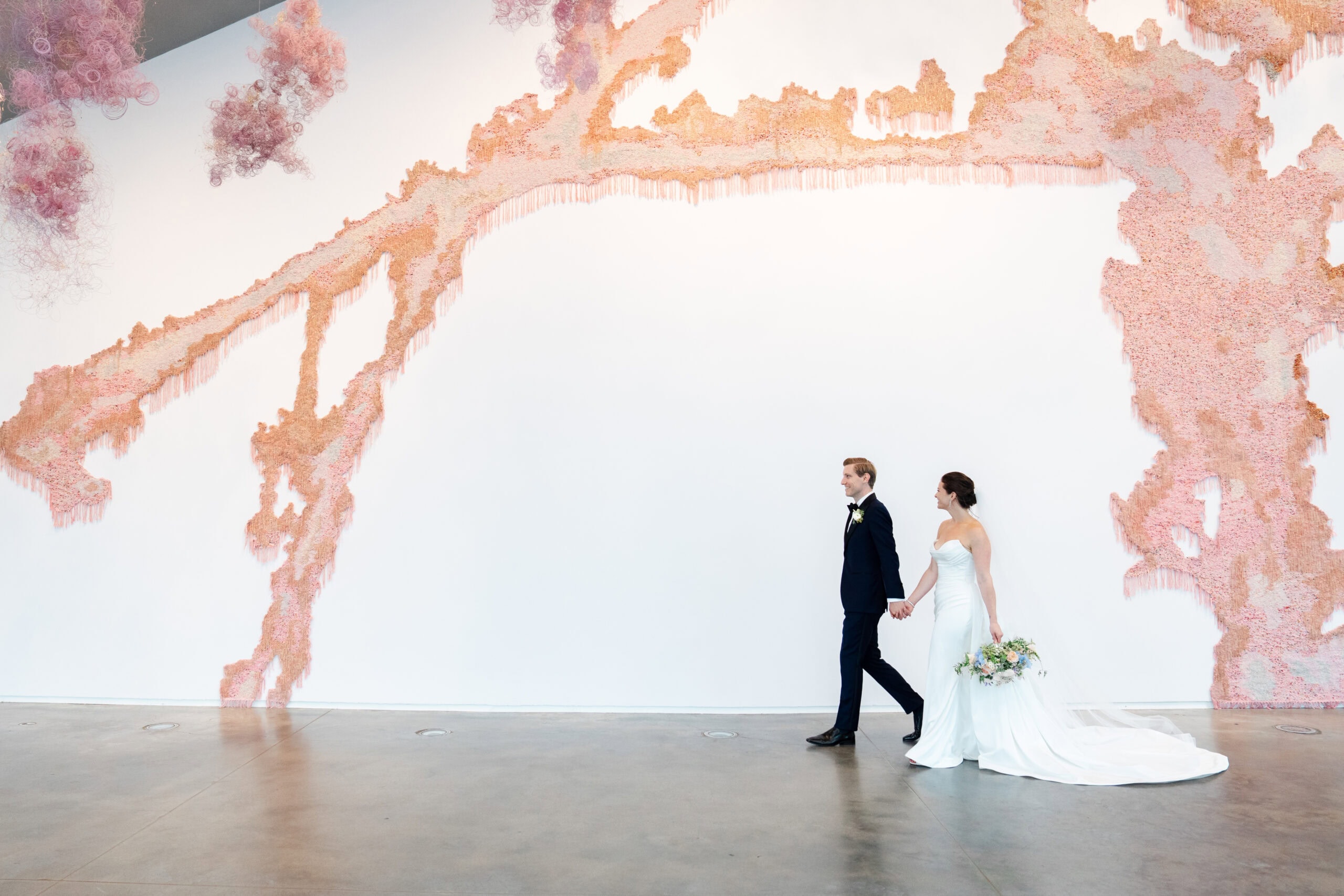 bride and groom holding hands walking during their ica boston wedding in massachusetts