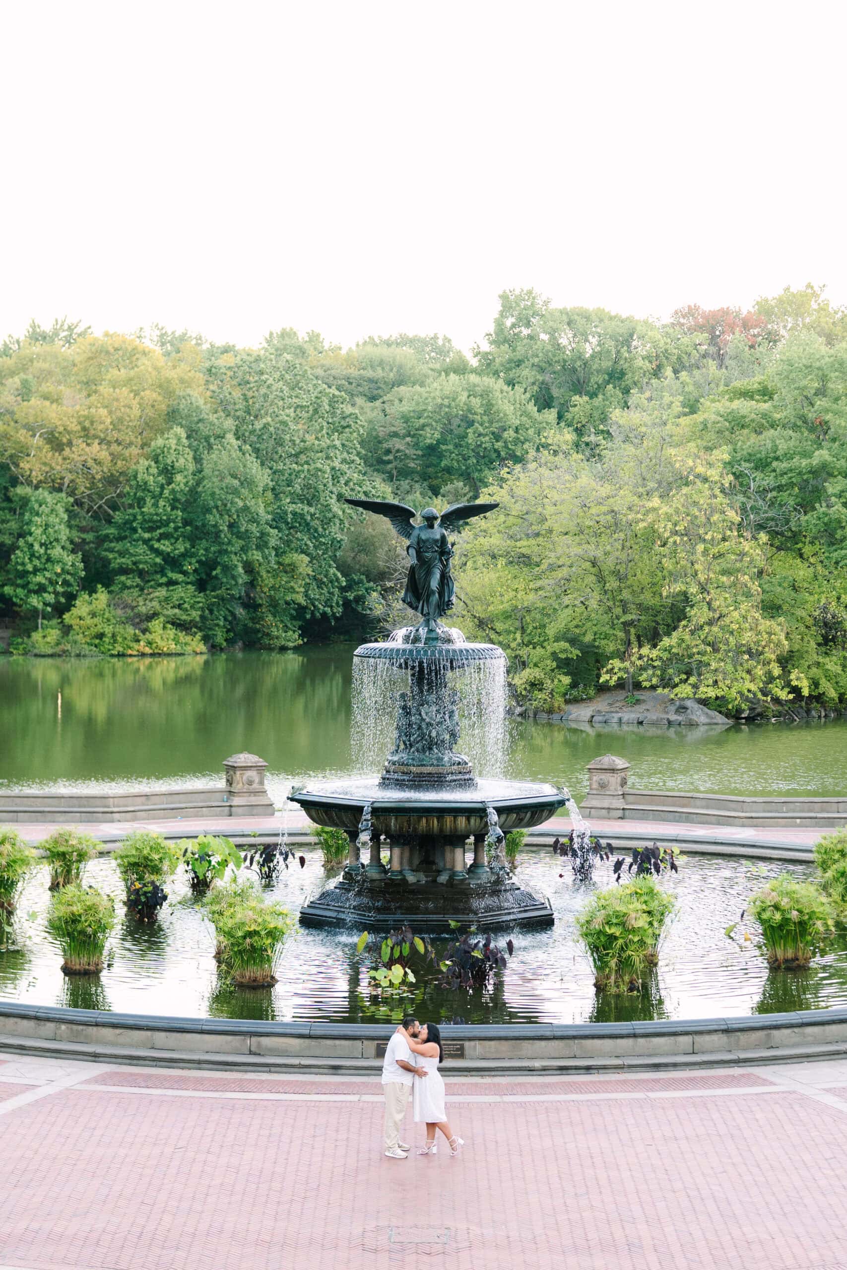 couple kissing at bethesda fountain captured by nyc engagement photographer meghan lynch