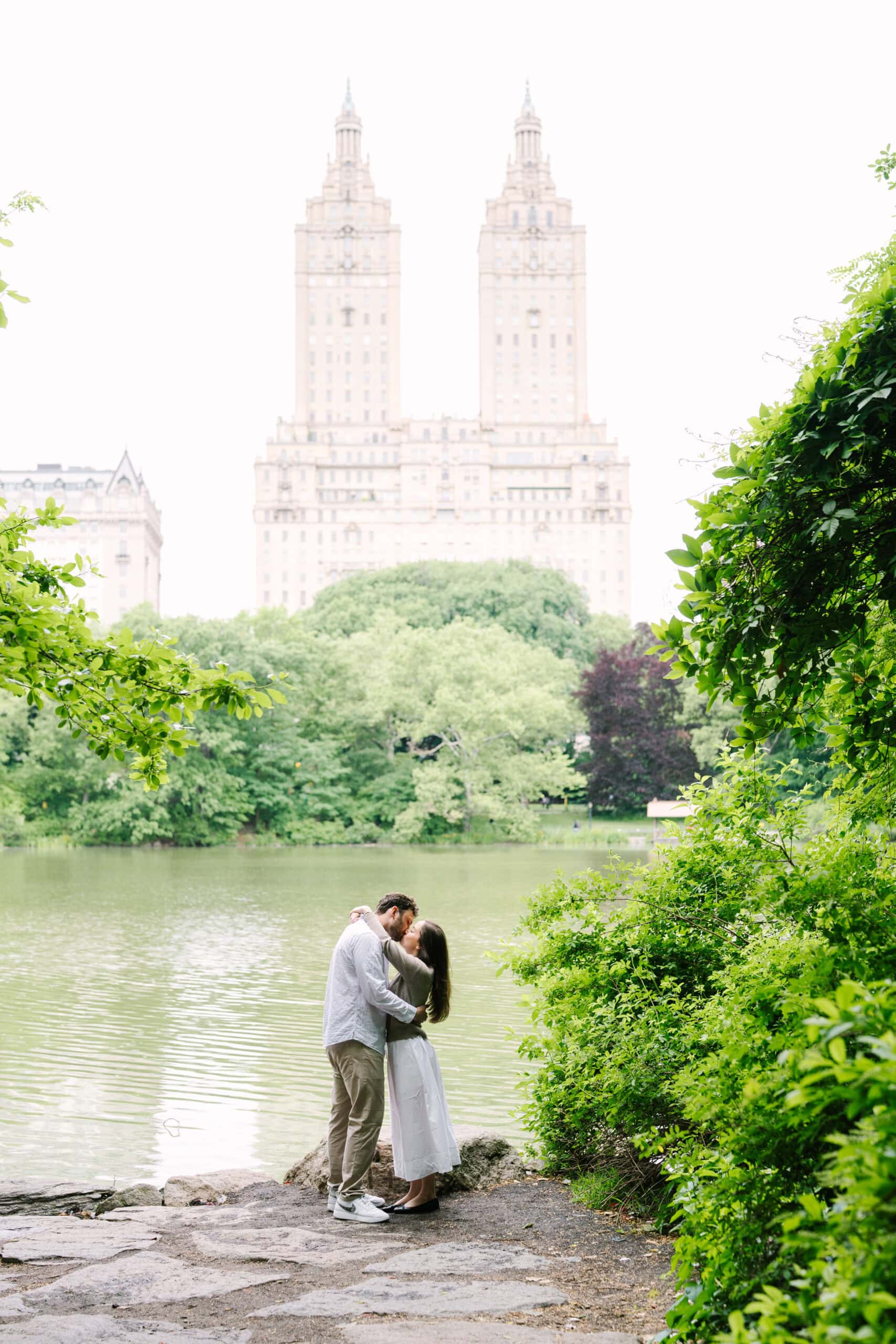 newly engaged couple kissing at the san remo lookout after their central park proposal