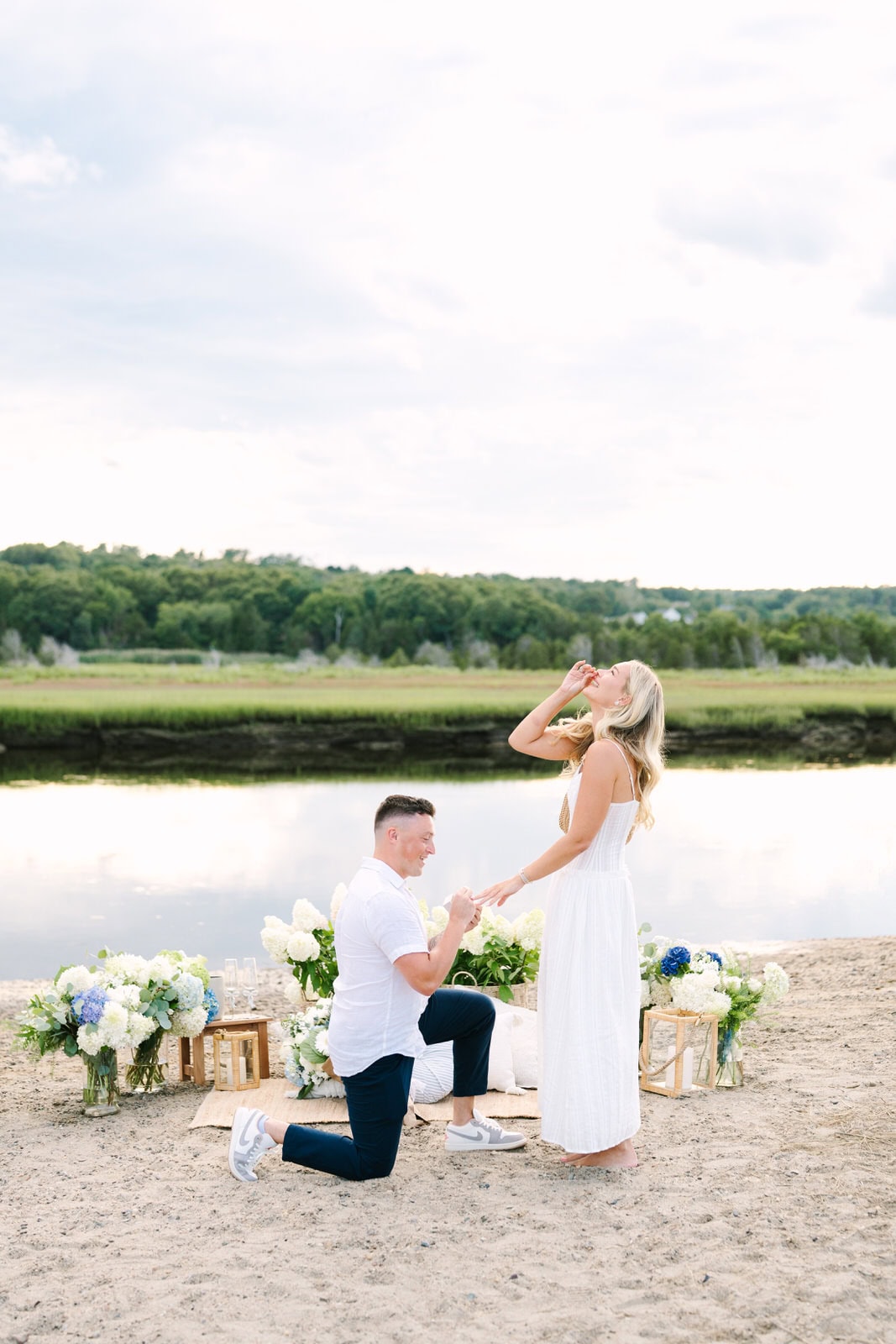 surprise engagement photographer Meghan Lynch capturing a proposal at Rexhame Beach